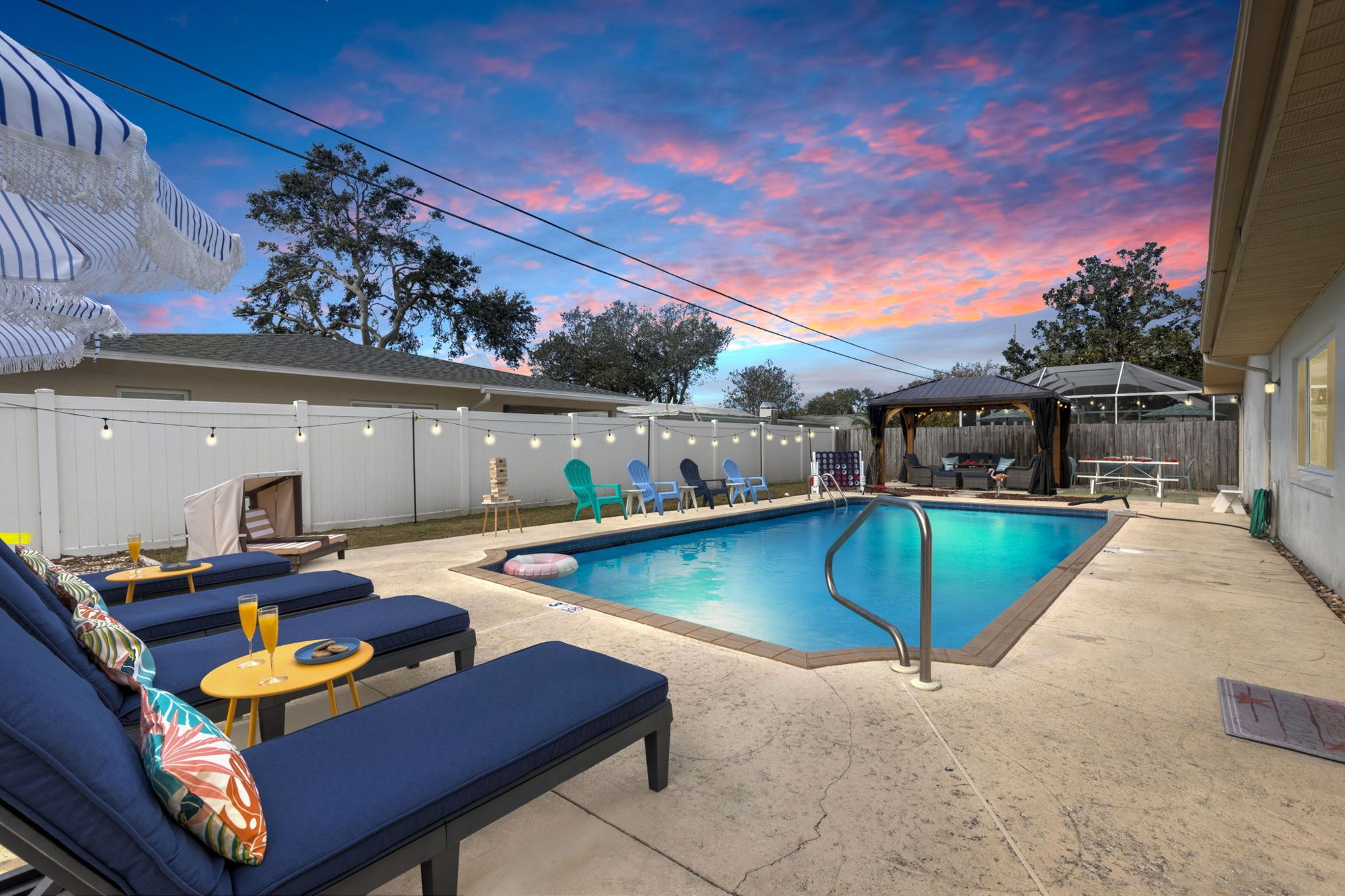 Sunset Escape private heated pool at golden hour with string lights in Largo, Florida