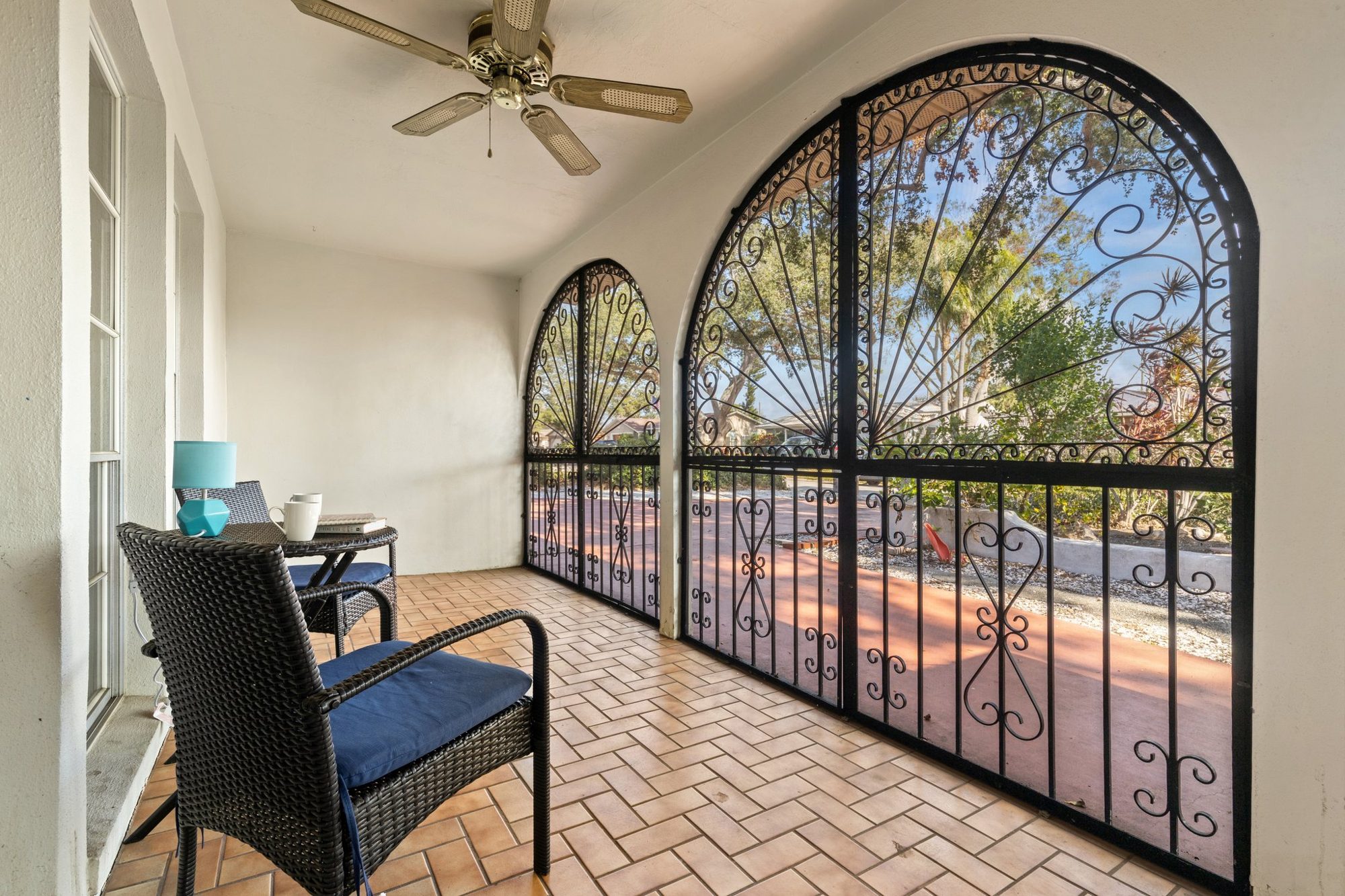 Screened patio with decorative wrought-iron gates at Sunset Escape